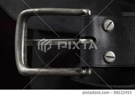 Black leather belt on a dark background. Leather products. Black leather belt on a dark background. Leather products. 99222455