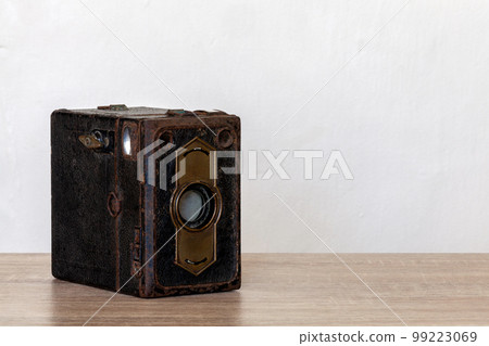 Vintage box camera on a wooden desk 99223069