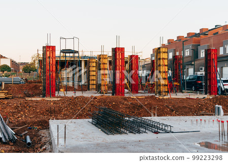 Construction site with steel formworks and reinforcing bars for pillars ready for concrete Construction site with steel formworks and reinforcing bars for pillars ready for concrete 99223298