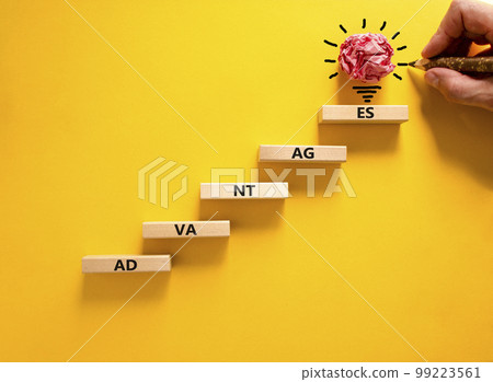 Advantages symbol. Wooden blocks stacking as step stair on beautiful yellow background, copy space. Businessman hand, light bulb icon. Word 'advantages'. Business and advantages concept. Advantages symbol. Wooden blocks stacking as step stair on beautiful yellow background, copy space. Businessman hand, light bulb icon. Word 'advantages'. Business and advantages concept. 99223561