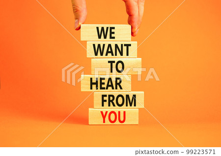 Support symbol. Concept words We want to hear from you on wooden blocks. Beautiful orange table orange background. Businessman hand. Business support we want to hear from you concept. Copy space. 99223571