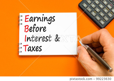 EBIT symbol. Concept words EBIT earnings before interest and taxes on white note on beautiful orange background. Business EBIT earnings before interest and taxes concept. Copy space. 99223630