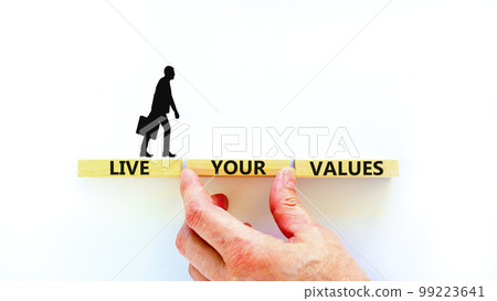 Live your values symbol. Concept words Live your values on wooden blocks. Businessman hand. Beautiful white table white background. Business, psychological and live your values concept. Copy space. Live your values symbol. Concept words Live your values on wooden blocks. Businessman hand. Beautiful white table white background. Business, psychological and live your values concept. Copy space. 99223641