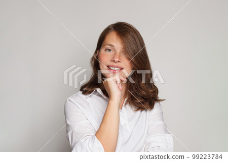 Portrait of beautiful nurse or doctor posing confidently while standing against white background Portrait of beautiful nurse or doctor posing confidently while standing against white background 99223784