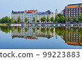 The deserted embankment in empty Helsinki wonderfully reflected in the water. 99223883