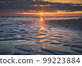 Sandy coast of Baltic Sea and reflection of sunset. 99223884