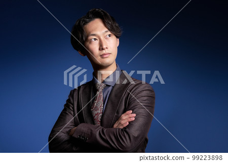 年輕的商人交叉著雙臂望向遠方 99223898