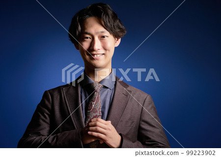 一個年輕的商人微笑著看著你 99223902