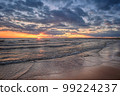 Baltic Sea panorama at sunset with shore waves and sun on horizon. 99224237