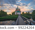 Summer landscape with an Orthodox church on the island and a bridge. 99224264