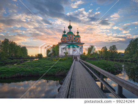 Summer landscape with an Orthodox church on the island and a bridge. 99224264