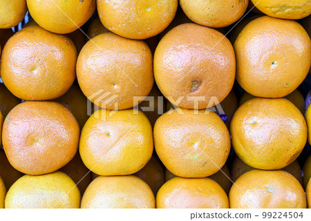 Grapefruits on fruit market background. Harvest of fresh juicy citruses on the supermarket counter. Grapefruits on fruit market background. Harvest of fresh juicy citruses on the supermarket counter. 99224504