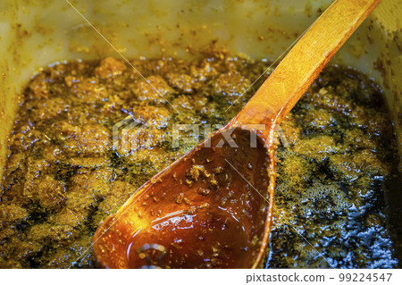 Thick honey with perga, wooden spoon. Healthy food concept, diet Thick honey with perga, wooden spoon. Healthy food concept, diet 99224547