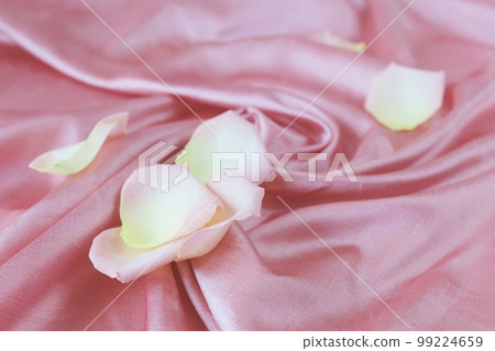 Fresh rose petals on pink natural silk fabric, top view, love emotion concept, Valentine's Day, background for congratulations, texture 99224659