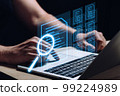 A person works at a laptop and does a document check. Business management. 99224989