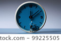 A miniature person riding a bike on the blue face of an analogue clock, generative Ai 99225505