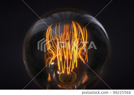Incandescent lamp on a black background close-up. Light bulb details 99225568