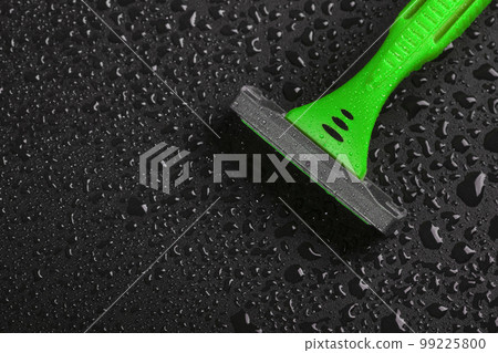 Razor with drops of water on a black background. Top view. Skin care concept 99225800