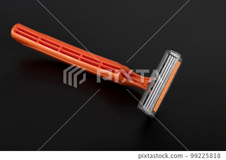 Razor on a black background. New disposable razor blade. Skin care concept Razor on a black background. New disposable razor blade. Skin care concept 99225818