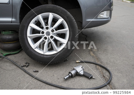 The car is at a car service. Replacing wheels on a car. Close-up The car is at a car service. Replacing wheels on a car. Close-up 99225984