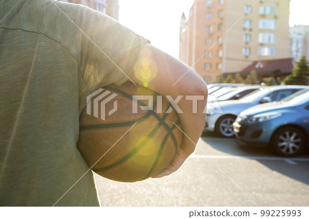 Rear view of a basketball player holding a ball. Close-up Rear view of a basketball player holding a ball. Close-up 99225993
