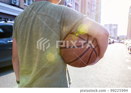 Back view of a man holding a basketball. Close-up Back view of a man holding a basketball. Close-up 99225994