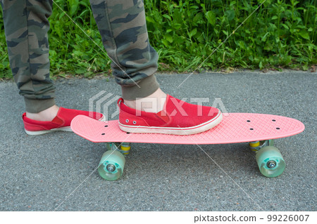 Plastic skate and legs closeup. Healthy lifestyle Plastic skate and legs closeup. Healthy lifestyle 99226007
