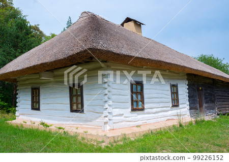 Old wooden house, with a thatched roof 99226152