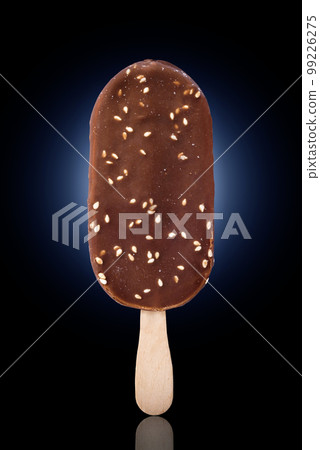 Beautiful ice cream with nuts on a black-blue background Beautiful ice cream with nuts on a black-blue background 99226275