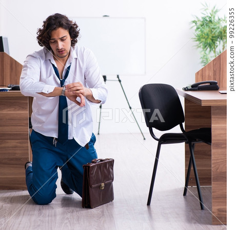Young male employee unhappy with excessive work 99226355