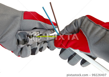Electrician removes insulation from a three-core copper wire with a stripper cutter 99226407