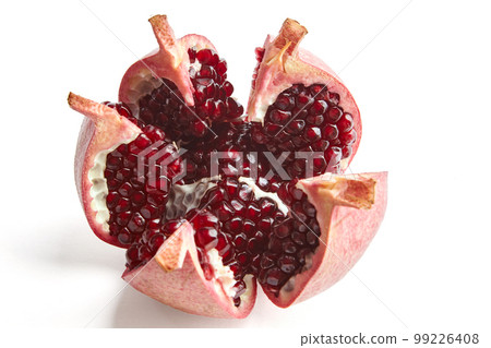 Beautifully cut broken ripe pomegranate isolated on white background. 99226408