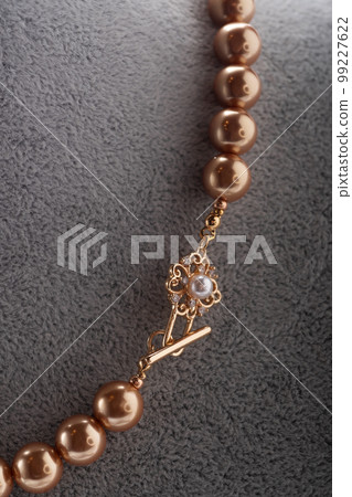 author handmade golden pearls necklace presented on maneken. fashion and jewelry concept. macro shot author handmade golden pearls necklace presented on maneken. fashion and jewelry concept. macro shot 99227622