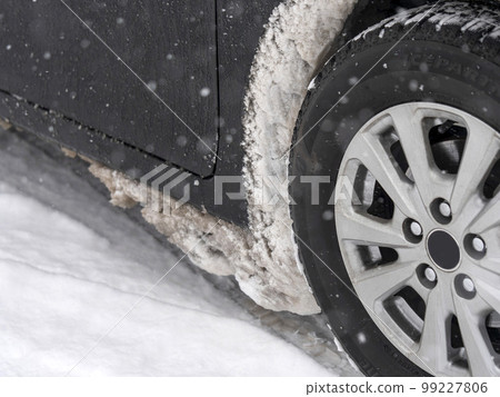 A lump of snow stuck in a tire house A lump of snow stuck in a tire house 99227806