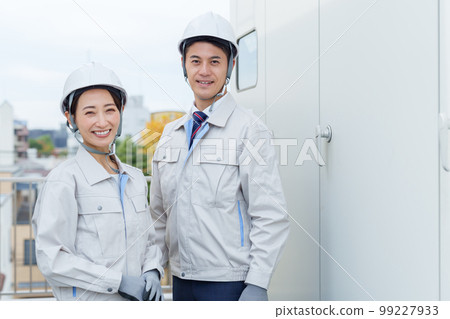 Portrait of a worker inspecting a switchboard 99227933