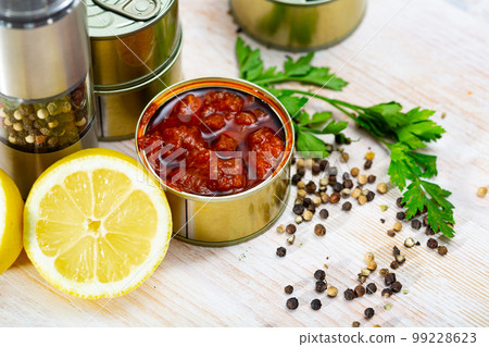 Tasty squids in American Salsa on background with greens and lemon Tasty squids in American Salsa on background with greens and lemon 99228623