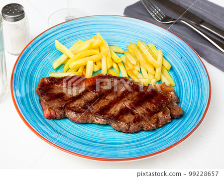 Tasty grilled beef tenderloin with french fries served 99228657