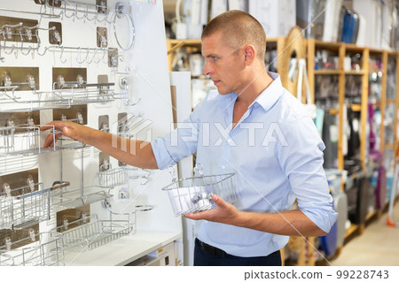 Man searching new bathroom accessories 99228743