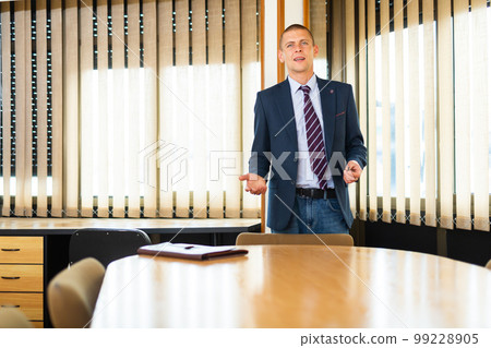Portrait of man welcoming to modern office Portrait of man welcoming to modern office 99228905