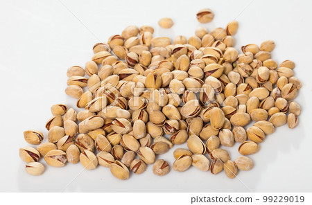 Heap of unshelled salted pistachios Heap of unshelled salted pistachios 99229019
