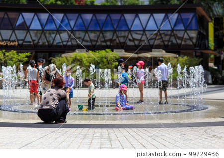 Children playing in the water 99229436