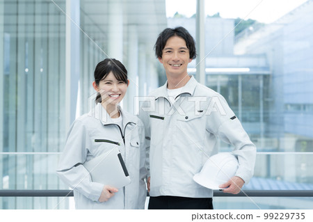 Portrait of two young male and female workers Portrait of two young male and female workers 99229735