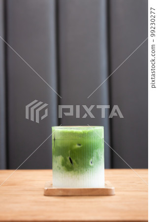 Iced matcha greentea on wooden table 99230277