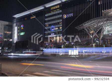 Illuminated Hakata Station at night and light trails of cars running in front of the station | Night view image | Hakata, Fukuoka City, Fukuoka Prefecture 99232504