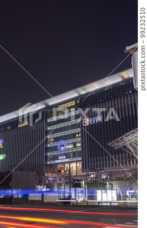 Illuminated Hakata Station at night and light trails of cars running in front of the station | Night view image | Hakata, Fukuoka City, Fukuoka Prefecture 99232510