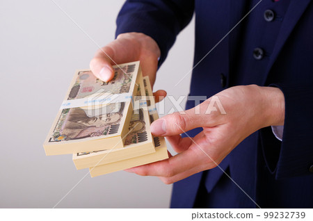 A man in a suit holding a lot of money 99232739