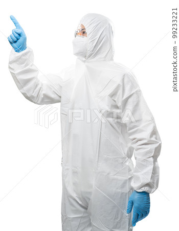 Worker wears medical protective suit or white coverall suit with mask and goggles finger point Worker wears medical protective suit or white coverall suit with mask and goggles finger point 99233221