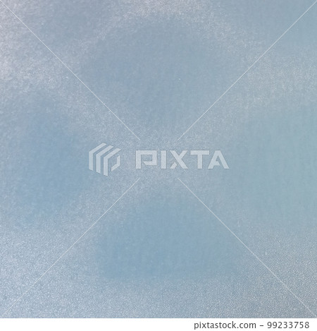 The frozen hood of the car. Frost on the metal surface of the car with a blue blur effect. Abstract background and texture for design. The frozen hood of the car. Frost on the metal surface of the car with a blue blur effect. Abstract background and texture for design. 99233758