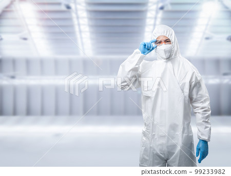 Worker wears medical protective suit or coverall suit with mask and goggles Worker wears medical protective suit or coverall suit with mask and goggles 99233982