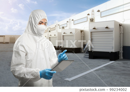 Asian worker or engineer wear protective coverall suit work at warehouse Asian worker or engineer wear protective coverall suit work at warehouse 99234002